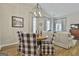 Open dining area with a chandelier, wood table, patterned chairs, and easy access to the living room at 1025 Pinehurst Dr, Peachtree City, GA 30269