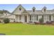Charming home with a well-manicured lawn, beautiful landscaping, and a welcoming front entrance at 1025 Pinehurst Dr, Peachtree City, GA 30269