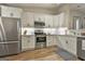 Modern kitchen features stainless steel appliances, white cabinets, and sleek countertops at 1025 Pinehurst Dr, Peachtree City, GA 30269