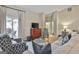 Well-lit living room with comfortable seating, a patio view, and a cozy, inviting atmosphere at 1025 Pinehurst Dr, Peachtree City, GA 30269