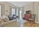 Bright living room with large windows, comfortable sofas, and a seamless connection to the outdoors at 1025 Pinehurst Dr, Peachtree City, GA 30269
