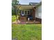 Back patio with grill, table, and wood stairs at 619 E College St, Bowdon, GA 30108