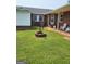 Backyard with a brick fire pit and covered porch at 619 E College St, Bowdon, GA 30108