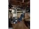 Basement with mechanical equipment, including a furnace and hot water heater, for essential home systems at 619 E College St, Bowdon, GA 30108