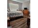 Cozy bedroom featuring a wood bed frame, dresser, and wood flooring at 619 E College St, Bowdon, GA 30108