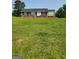 Charming one-story brick home with a neatly mowed front yard and a classic white door at 619 E College St, Bowdon, GA 30108