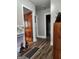 Hallway with hardwood floors and decorative items, leading to various rooms at 619 E College St, Bowdon, GA 30108