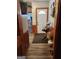 Inviting hallway with wood-paneled walls and a decorative table lamp near the front door at 619 E College St, Bowdon, GA 30108