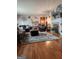 Inviting living room with hardwood floors, neutral walls, fireplace, comfortable sofas and stylish decor at 619 E College St, Bowdon, GA 30108