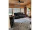 Cozy sunroom with wood walls, brick accents, comfortable seating, and bright natural light at 619 E College St, Bowdon, GA 30108