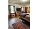 Cozy main bedroom featuring hardwood floors and a large flat-screen TV on a dresser at 619 E College St, Bowdon, GA 30108