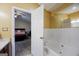 Bright bathroom featuring a luxurious soaking tub and an open doorway to an inviting bedroom at 6403 Heritage Run, Morrow, GA 30260