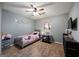 Charming bedroom with a ceiling fan, plush carpet, and playful decor for a cozy atmosphere at 6403 Heritage Run, Morrow, GA 30260
