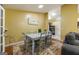 Open dining area featuring a table set for six and filled with natural light and hardwood flooring at 6403 Heritage Run, Morrow, GA 30260