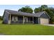 Charming single-story home with a covered front porch, attached garage, and well-maintained lawn at 6403 Heritage Run, Morrow, GA 30260