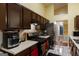 Functional kitchen with wood cabinets, appliances, and a view of the hallway at 6403 Heritage Run, Morrow, GA 30260