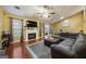 Cozy living room with a fireplace, large sectional sofa, and open access to the dining area and backyard at 6403 Heritage Run, Morrow, GA 30260