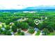 A scenic aerial view highlighting the homes nestled among a dense green forest and quiet neighborhood streets at 329 Royal Crescent Way, Stockbridge, GA 30281