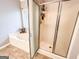 Bathroom featuring a soaking tub and a glass-enclosed shower, with tile flooring at 329 Royal Crescent Way, Stockbridge, GA 30281
