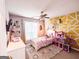 Bright bedroom featuring a unique yellow geometric wall and playful decor at 329 Royal Crescent Way, Stockbridge, GA 30281
