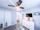 Bedroom showcasing a ceiling fan, closet, and dresser with mounted television at 329 Royal Crescent Way, Stockbridge, GA 30281