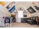 Bonus room decorated with sports memorabilia, featuring a tv, black sofa, and a foosball table at 329 Royal Crescent Way, Stockbridge, GA 30281