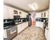 Bright kitchen features white cabinets, green tile countertops, stainless steel appliances, and tile floors at 329 Royal Crescent Way, Stockbridge, GA 30281