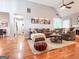 Inviting living room with hardwood floors, neutral paint, and vaulted ceiling at 329 Royal Crescent Way, Stockbridge, GA 30281