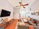 Bright living room boasts a high ceiling, hardwood floors, and modern decor at 329 Royal Crescent Way, Stockbridge, GA 30281