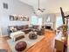 Spacious living room features a cozy fireplace, ceiling fan, and hardwood floors at 329 Royal Crescent Way, Stockbridge, GA 30281