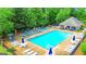 Community pool area featuring lounge chairs, tables and umbrellas for residents' enjoyment at 329 Royal Crescent Way, Stockbridge, GA 30281
