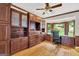 Executive home office with wood trim, custom cabinetry, granite counters, and bright bay window at 513 Viridian Vw, Peachtree City, GA 30269
