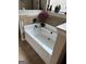 Relaxing bathroom with a soaking tub, neutral tile accents, and natural light at 860 Nevis Way, Mcdonough, GA 30253