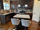 Modern kitchen featuring stainless steel appliances, granite countertops, and a functional center island at 860 Nevis Way, Mcdonough, GA 30253
