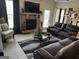 Cozy living room with a stone fireplace, plush leather seating, and a comfortable atmosphere at 860 Nevis Way, Mcdonough, GA 30253