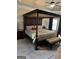 Spacious bedroom with a luxurious four-poster bed, complemented by soft lighting and warm tones at 860 Nevis Way, Mcdonough, GA 30253
