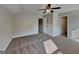 Spacious bedroom with soft carpet, a ceiling fan, and multiple entry doors at 471 Lanier Ct, Hiram, GA 30141