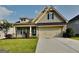 Charming two-story home with a well-manicured lawn, attached garage, and a welcoming front porch at 471 Lanier Ct, Hiram, GA 30141