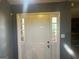 Elegant entryway with a white front door framed by sidelights and neutral-colored walls at 366 Montgomery Pl, Jonesboro, GA 30238