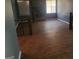 Spacious living room featuring wood-look tile floors, a stone fireplace, and natural light at 366 Montgomery Pl, Jonesboro, GA 30238