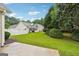 Large backyard with lush green grass and mature landscaping and partial hardscape at 412 Rock Creek Dr, Peachtree City, GA 30269
