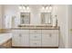 Bathroom with double granite vanity featuring updated cabinets and lighting at 412 Rock Creek Dr, Peachtree City, GA 30269