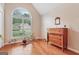 A quiet bedroom with hardwood flooring, a large window and natural light, and simple decor at 412 Rock Creek Dr, Peachtree City, GA 30269