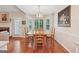 Sunny dining room shows bay window, pendant light, wood table and chairs, and hardwood floors at 412 Rock Creek Dr, Peachtree City, GA 30269