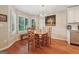 Bright dining room features hardwood floors, modern light fixture, and large windows with plantation shutters at 412 Rock Creek Dr, Peachtree City, GA 30269