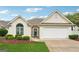 Charming single-Gathering home with well-maintained lawn, attached garage, and inviting front entrance at 412 Rock Creek Dr, Peachtree City, GA 30269