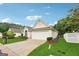 A beautifully landscaped front yard complements this home with an attached two-car garage at 412 Rock Creek Dr, Peachtree City, GA 30269