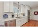 Well-appointed kitchen features stainless steel appliances, white cabinets, and beautiful marble countertops at 412 Rock Creek Dr, Peachtree City, GA 30269