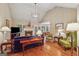 Inviting living room with a cozy fireplace, comfortable seating, and hardwood flooring at 412 Rock Creek Dr, Peachtree City, GA 30269