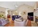 Spacious living room with a fireplace, hardwood flooring, and a comfortable seating arrangement at 412 Rock Creek Dr, Peachtree City, GA 30269